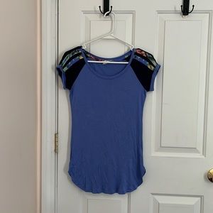 blue top with black short sleeves